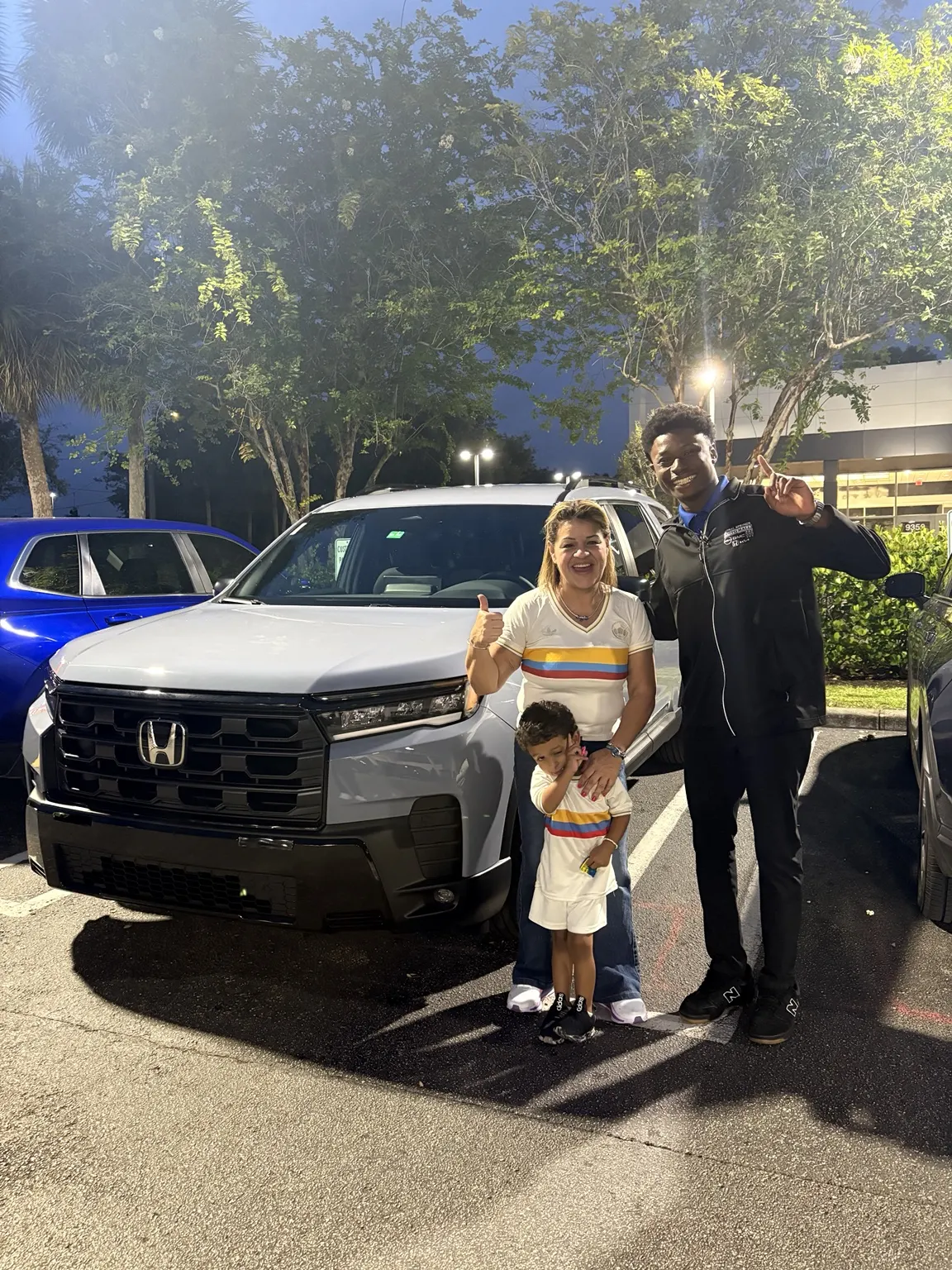 Greg with a customer and their vehicle