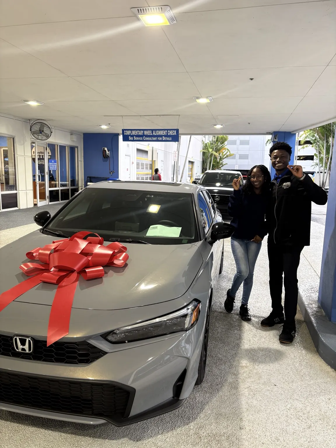 Greg with a customer and their vehicle