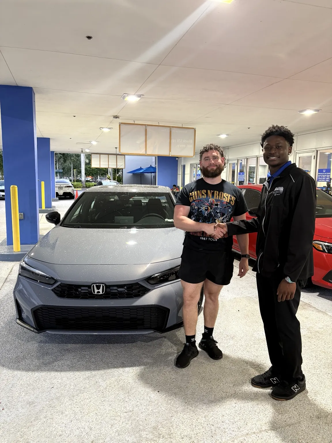 Greg with a customer and their vehicle