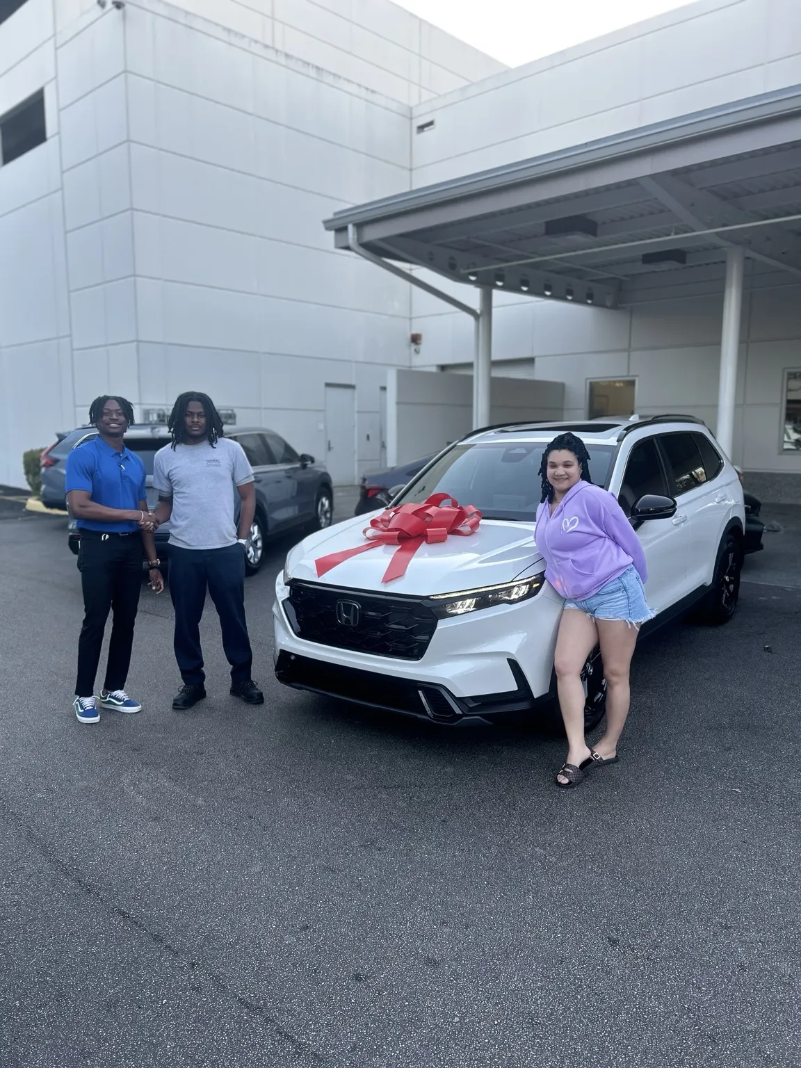 Greg with a customer and their vehicle