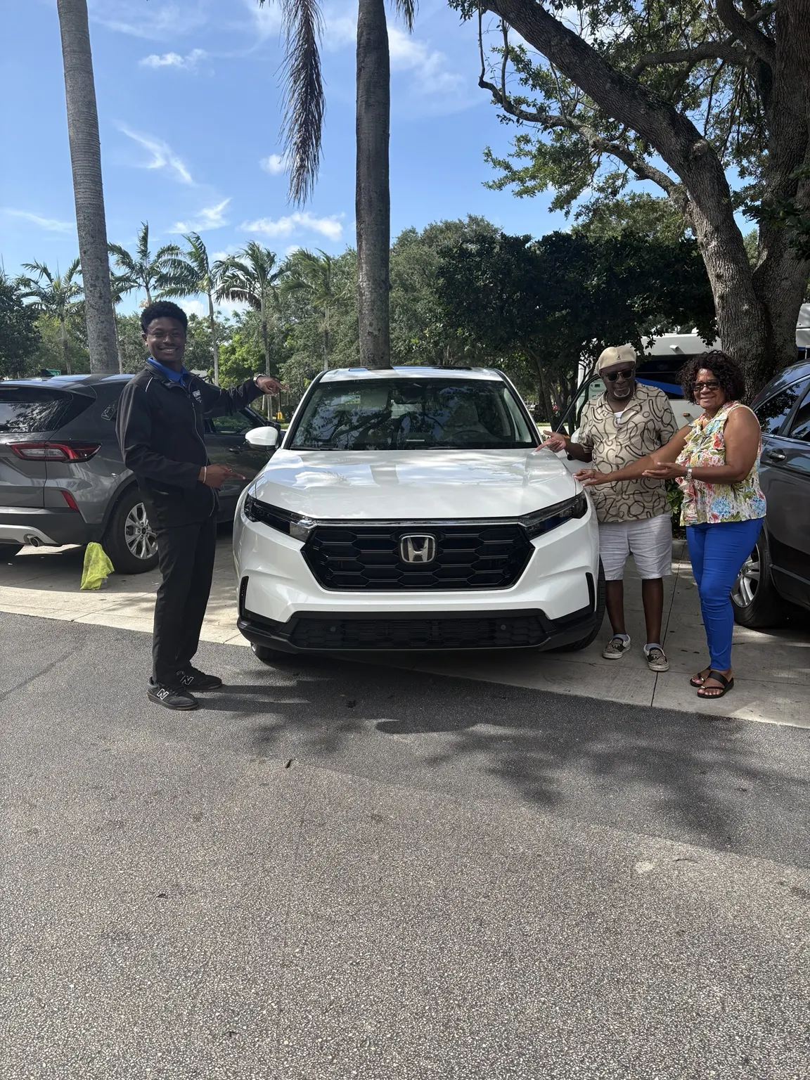 Greg with a customer and their vehicle