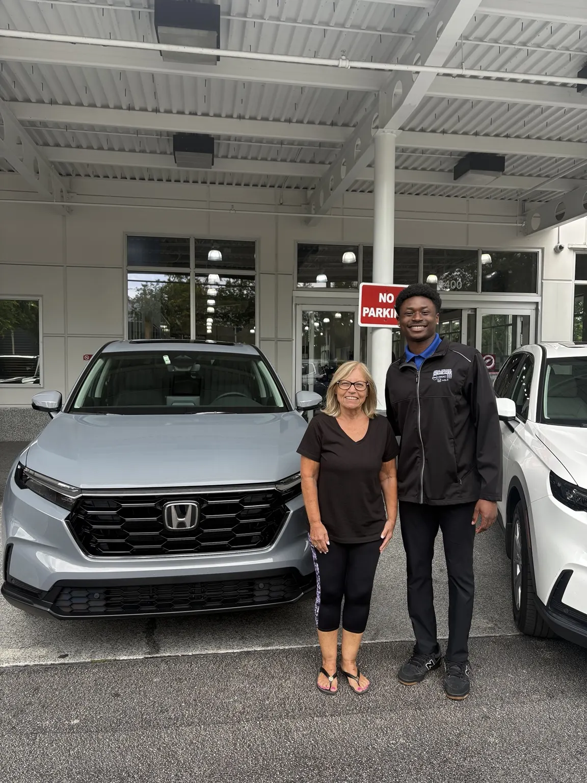 Greg with a customer and their vehicle