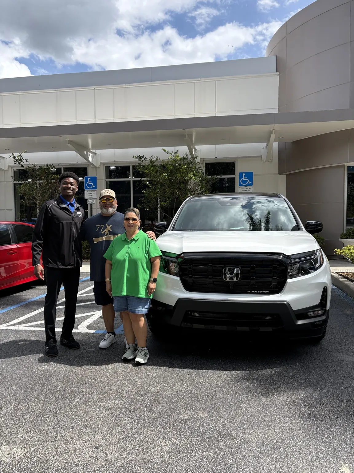 Greg with a customer and their vehicle