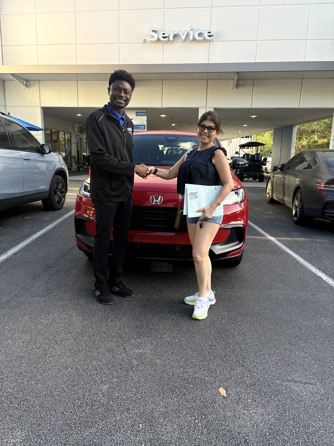 Greg with a customer and their vehicle