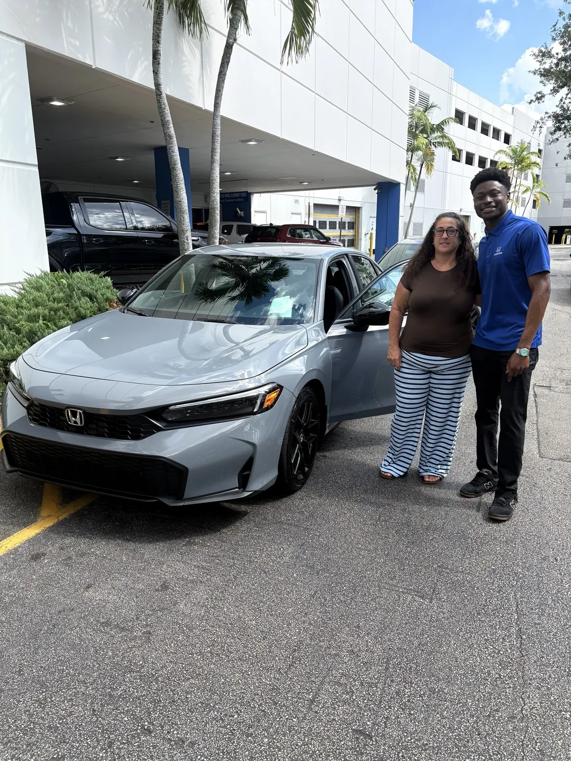 Greg with a customer and their vehicle