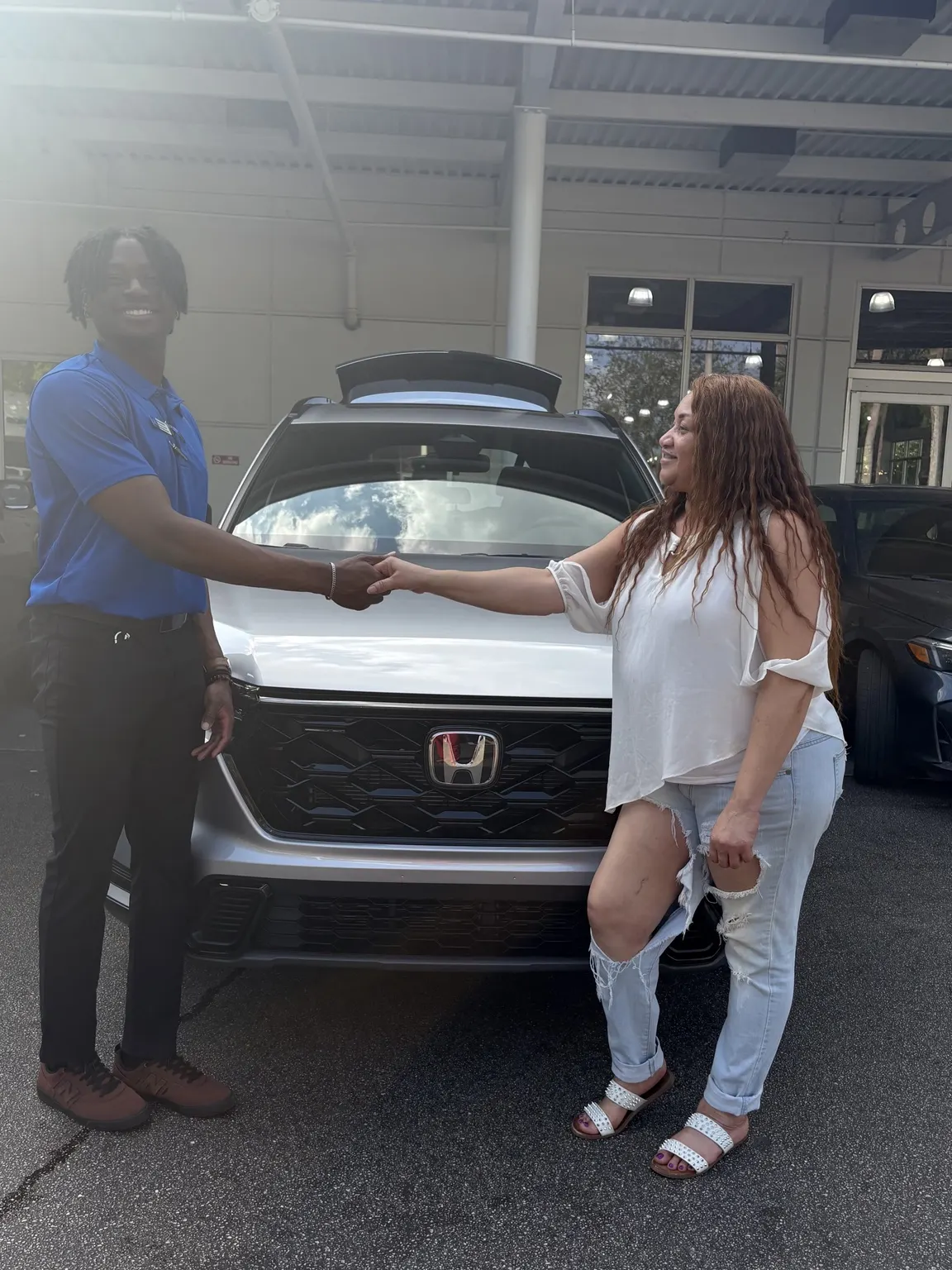 Greg with a customer and their vehicle