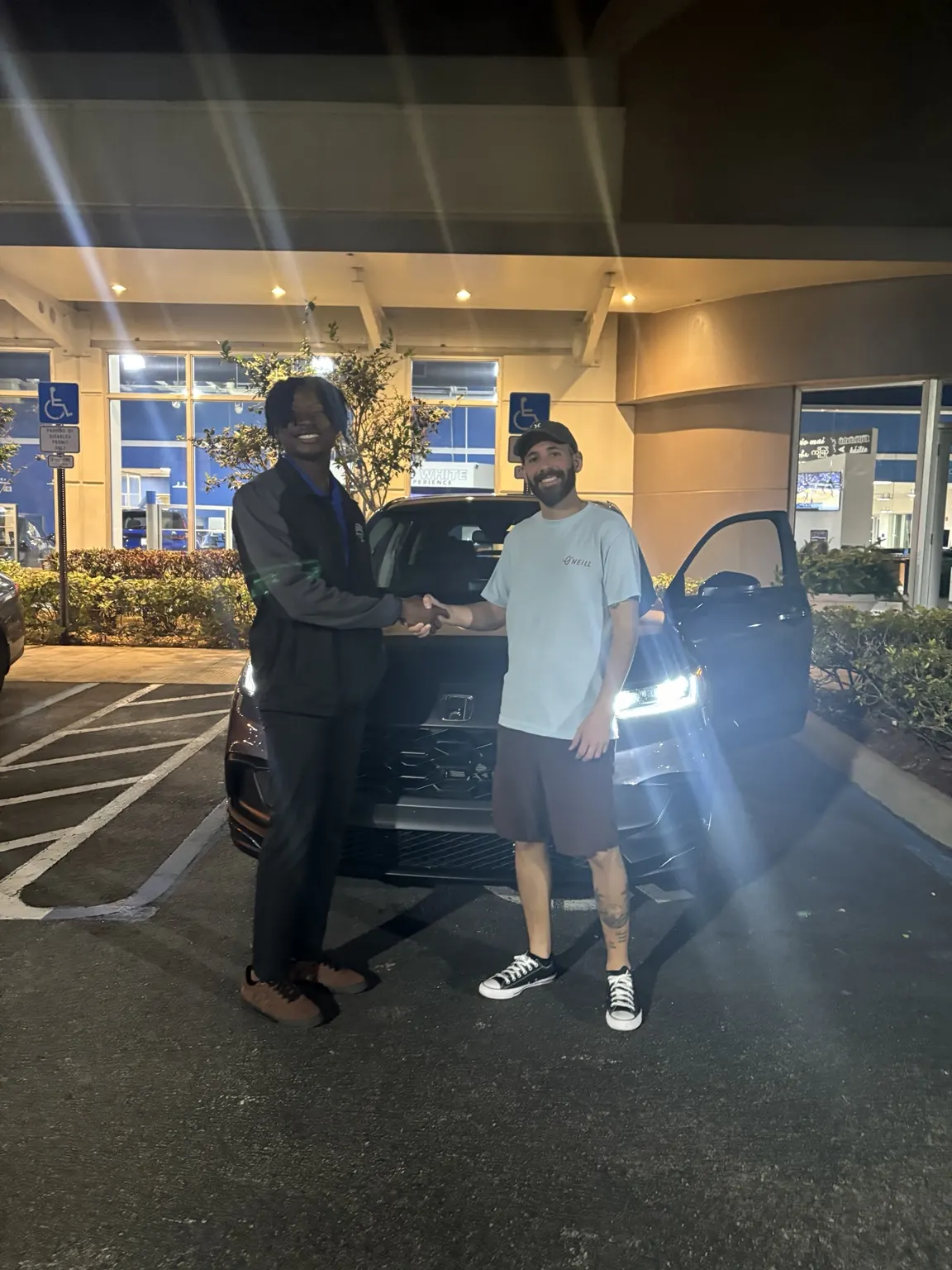 Greg with a customer and their vehicle