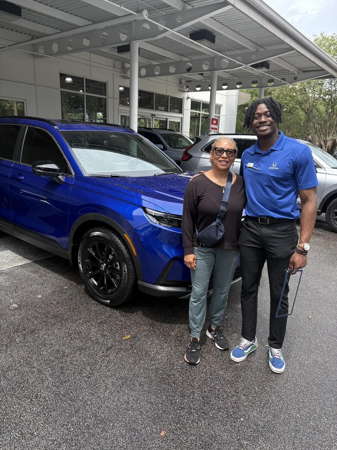 Greg with a customer and their vehicle