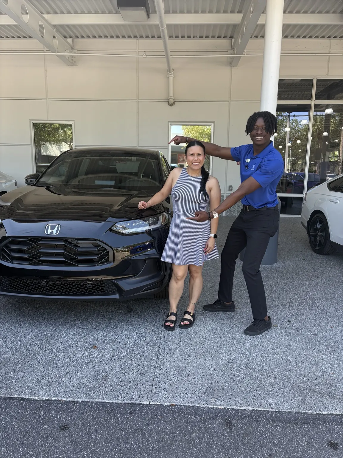 Greg with a customer and their vehicle