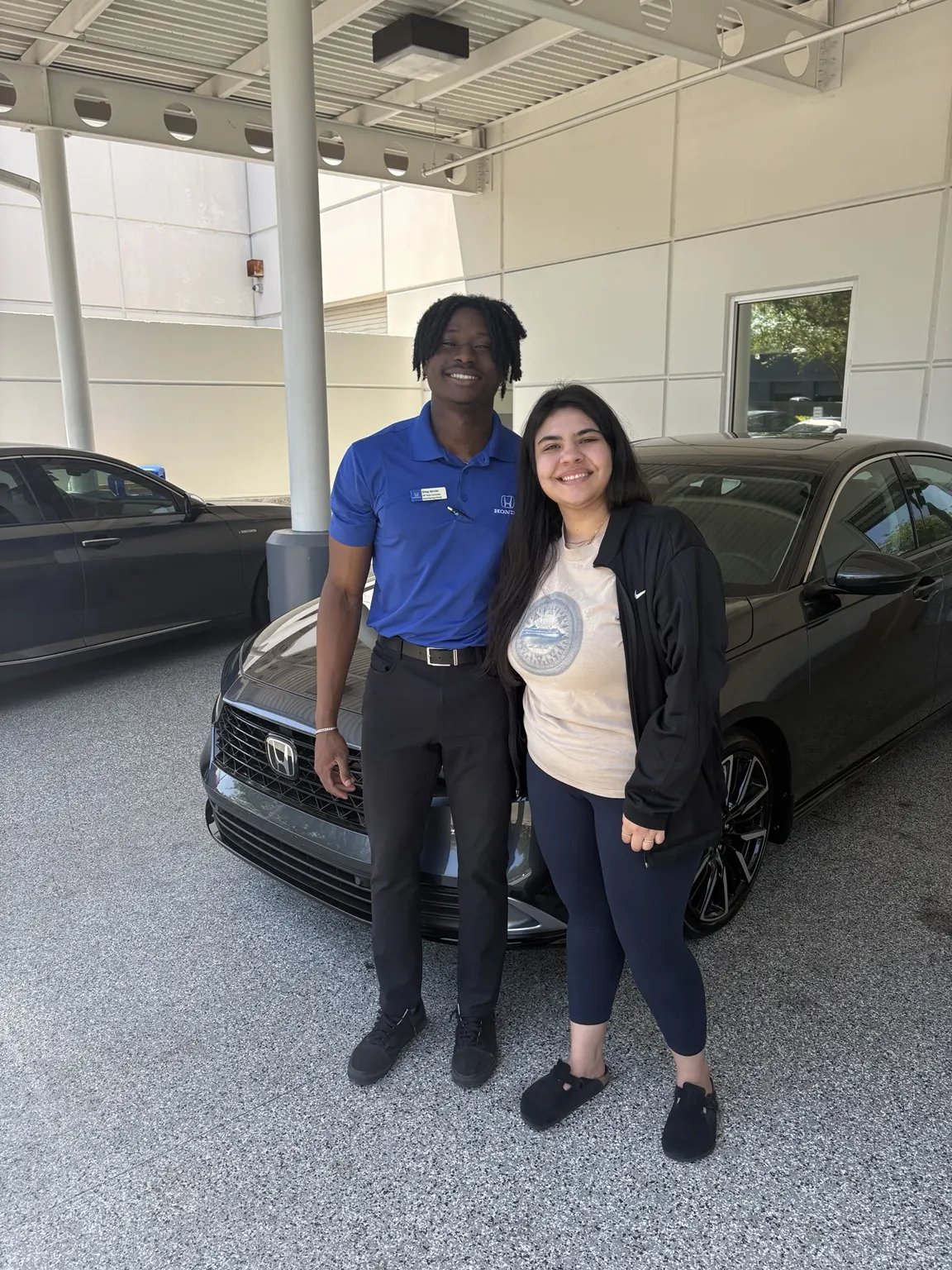 Greg with a customer and their vehicle
