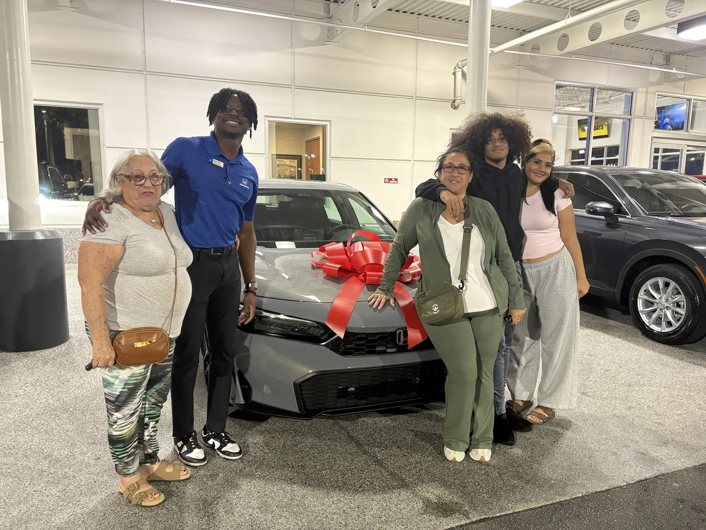 Greg with a customer and their vehicle