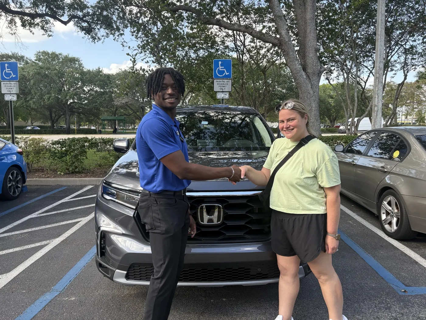 Greg with a customer and their vehicle