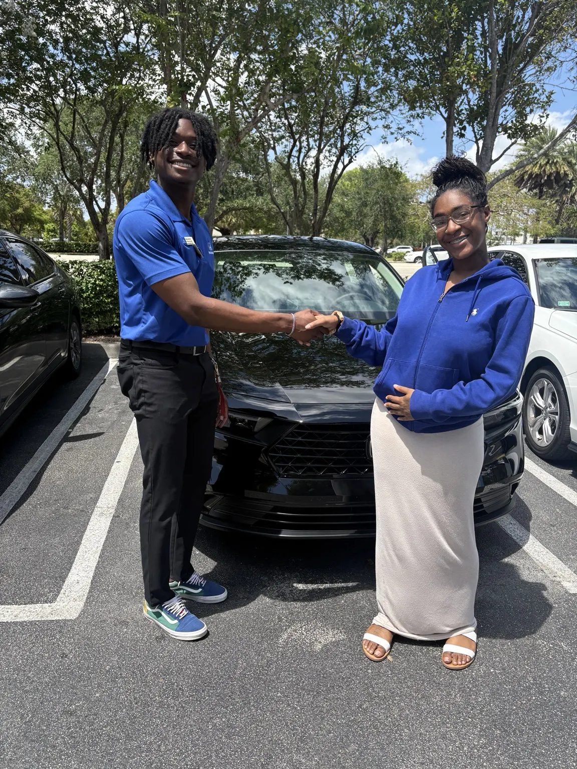 Greg with a customer and their vehicle