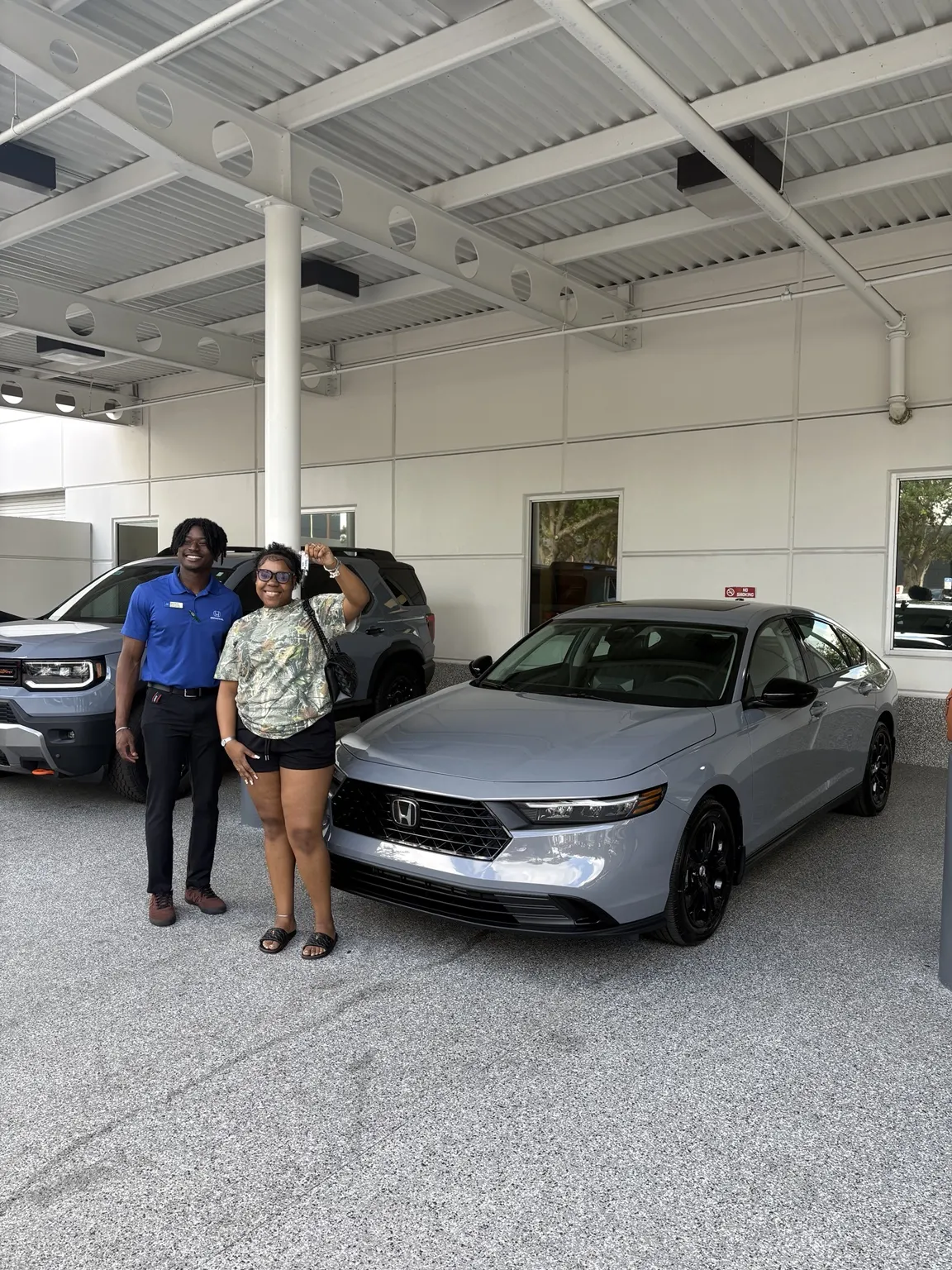 Greg with a customer and their vehicle