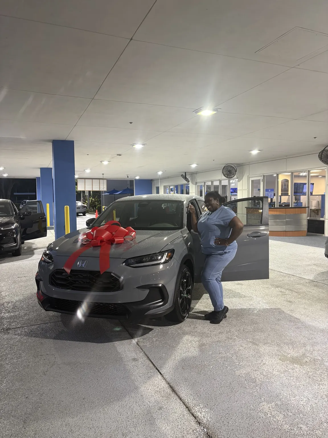 Greg with a customer and their vehicle