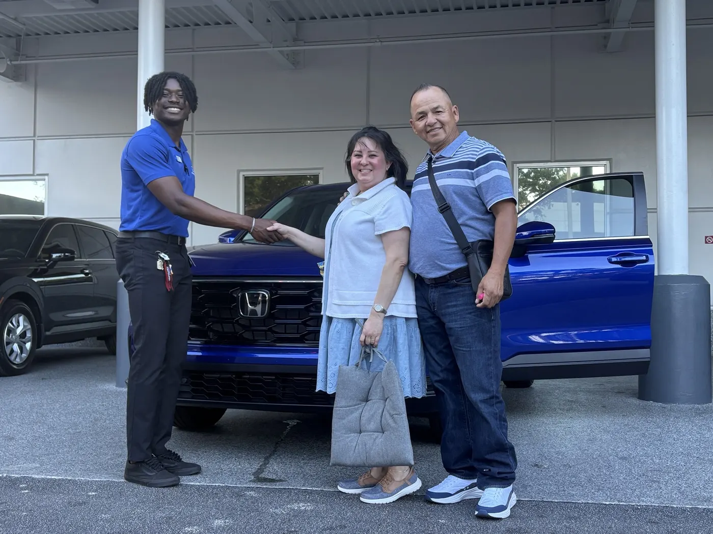 Greg with a customer and their vehicle