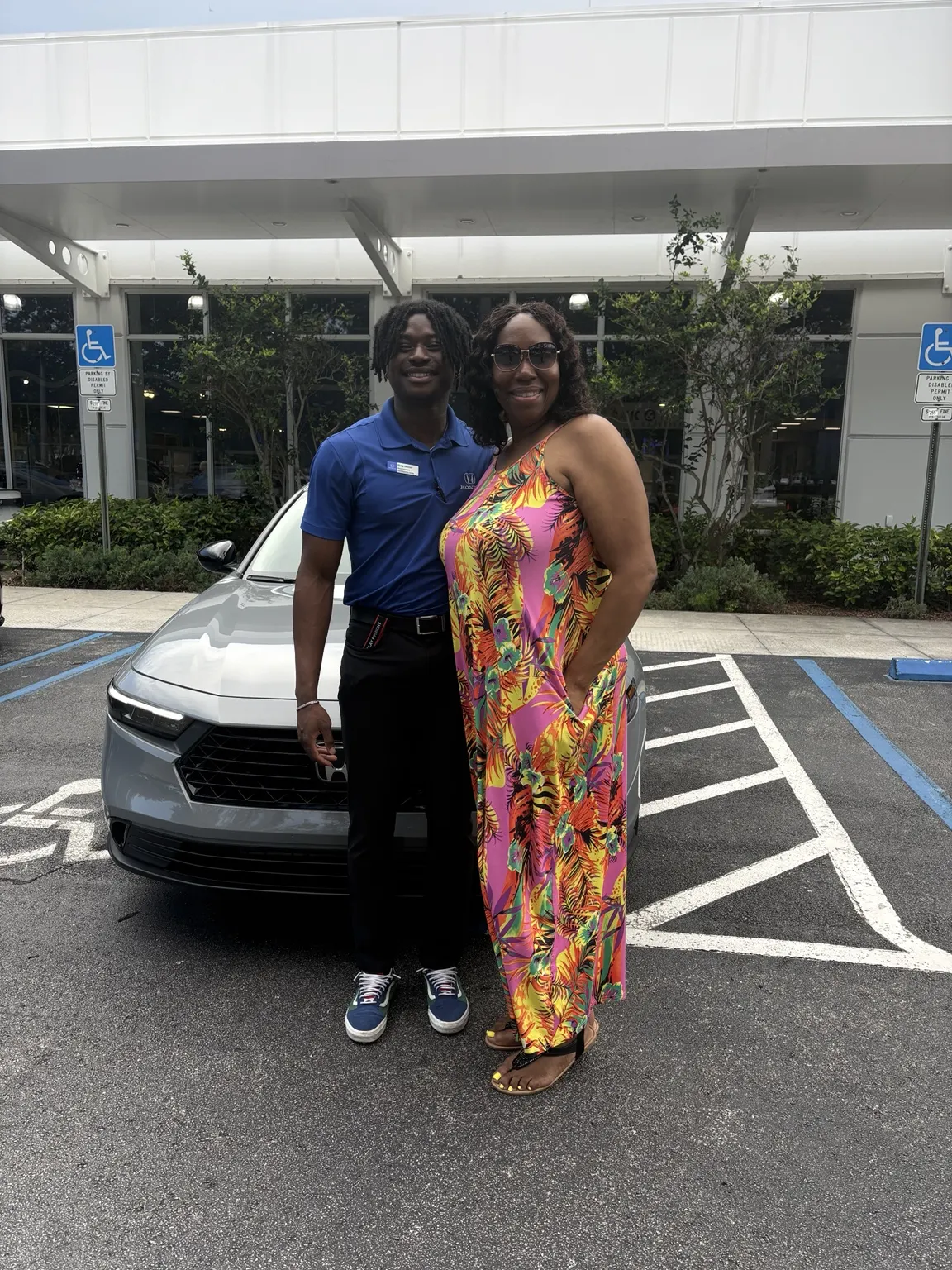 Greg with a customer and their vehicle
