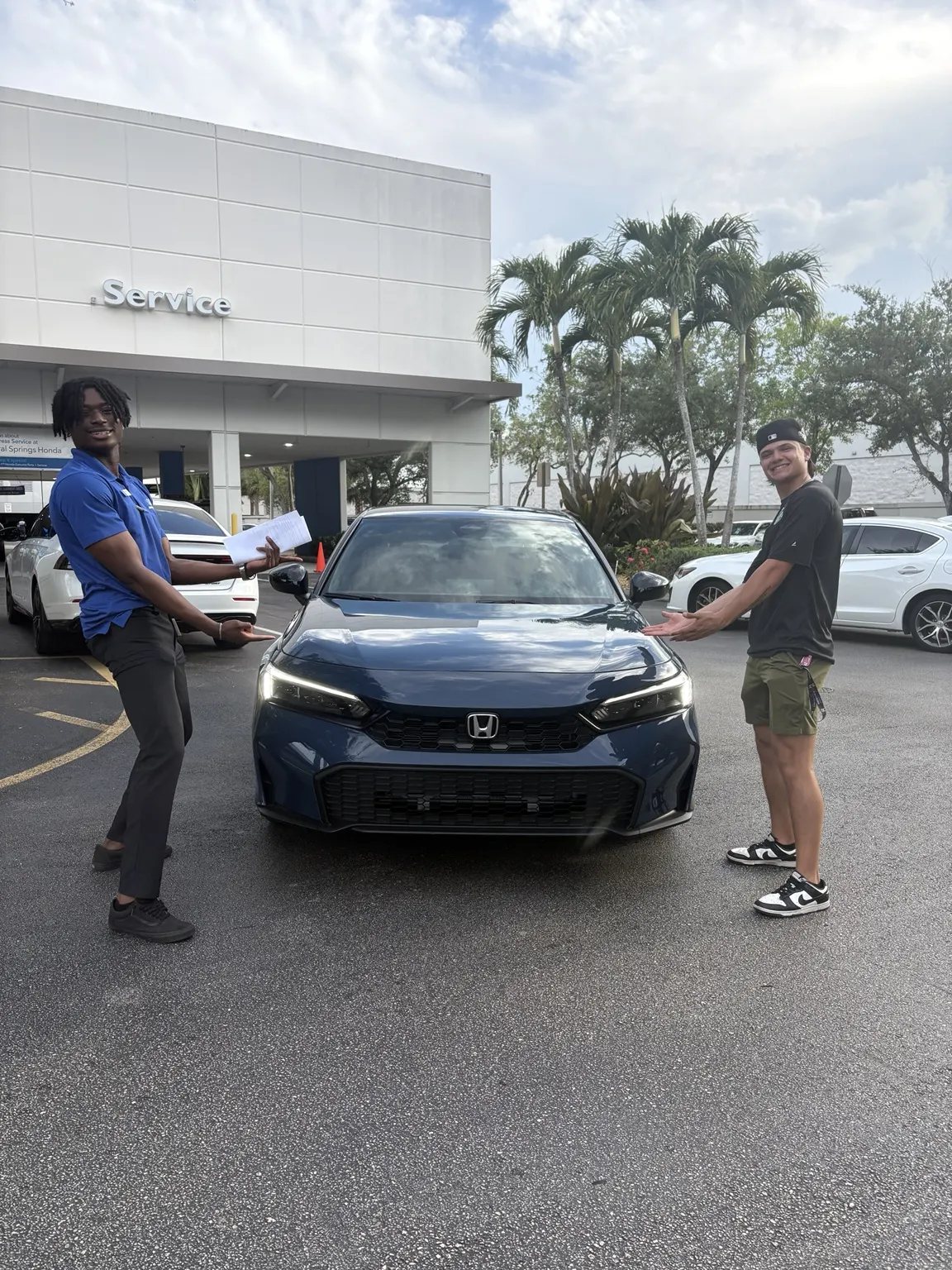 Greg with a customer and their vehicle