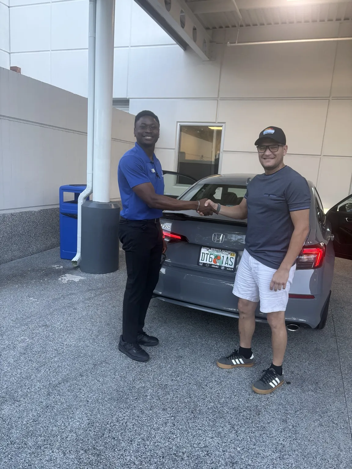 Greg with a customer and their vehicle