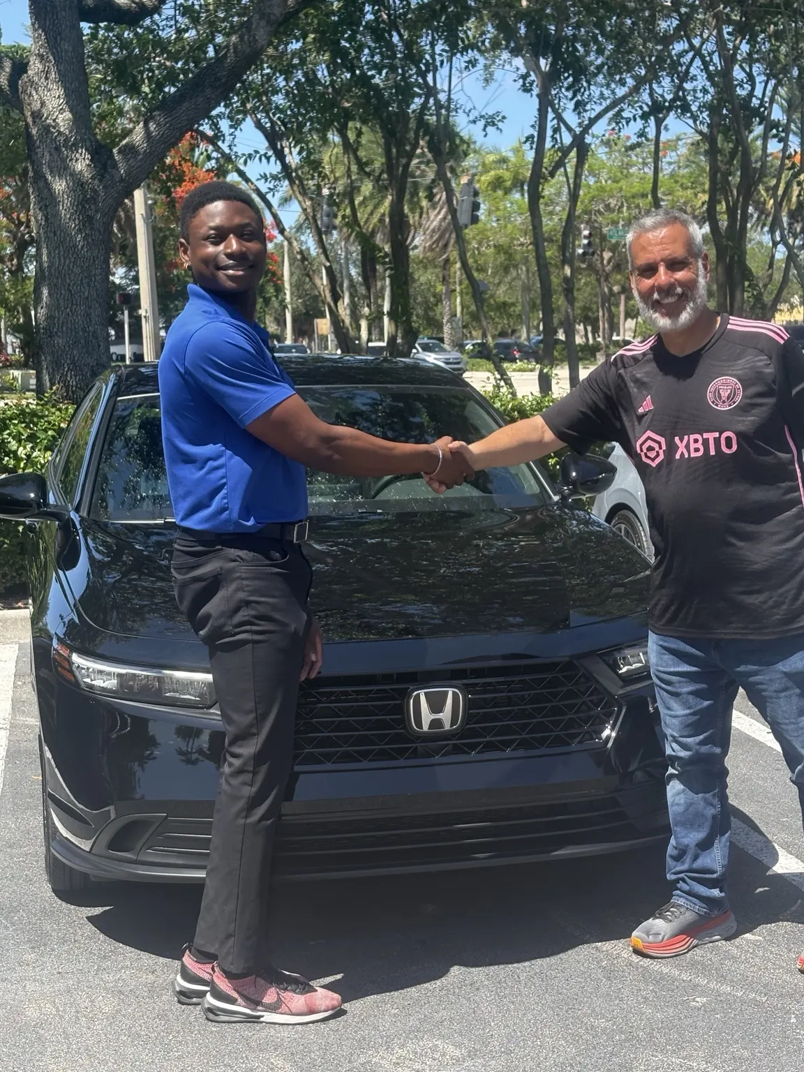 Greg with a customer and their vehicle