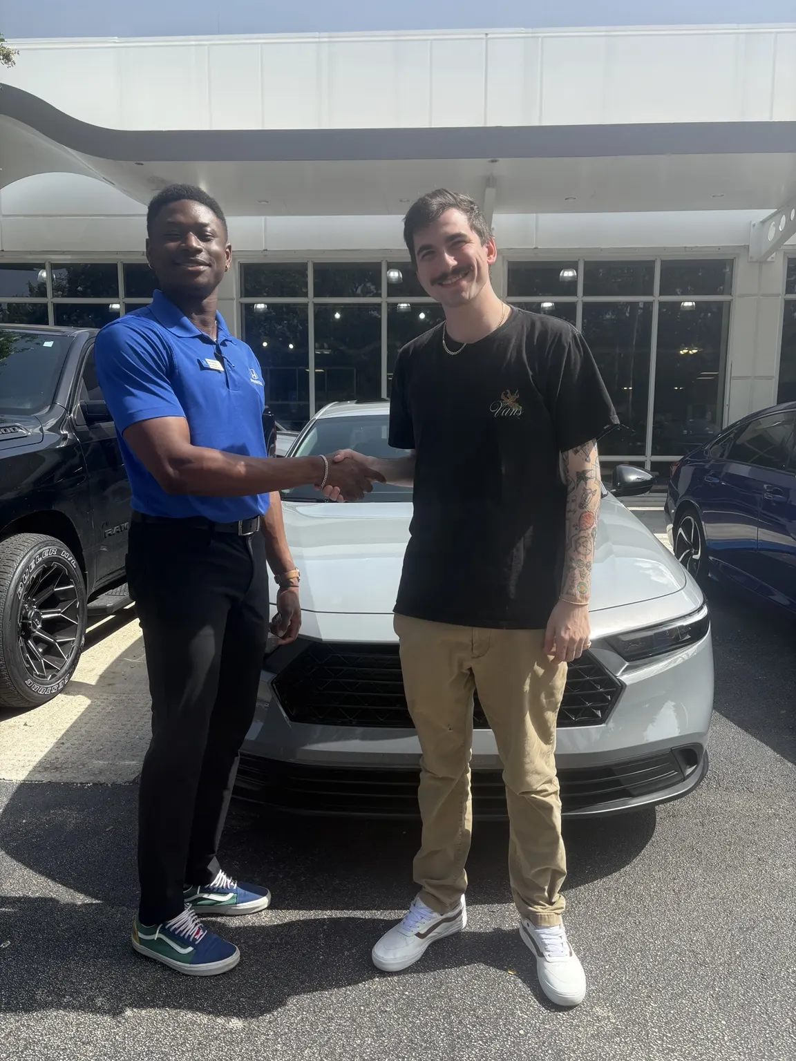 Greg with a customer and their vehicle