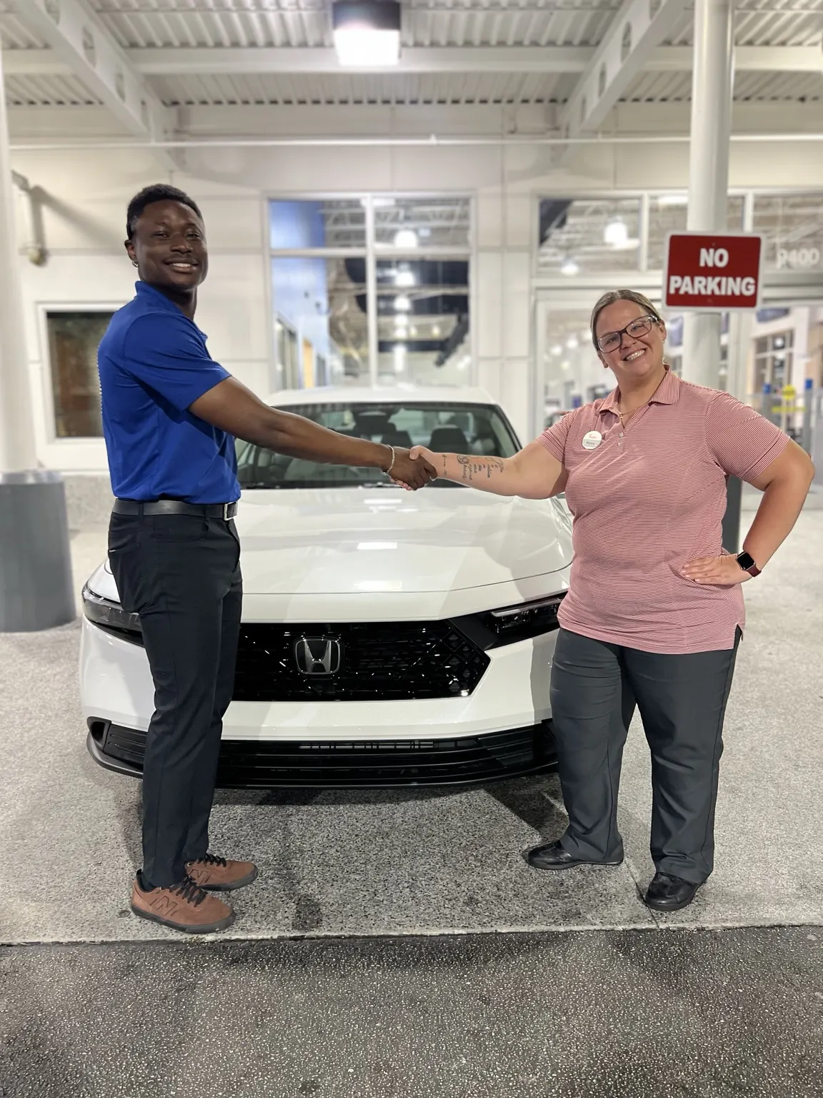 Greg with a customer and their vehicle