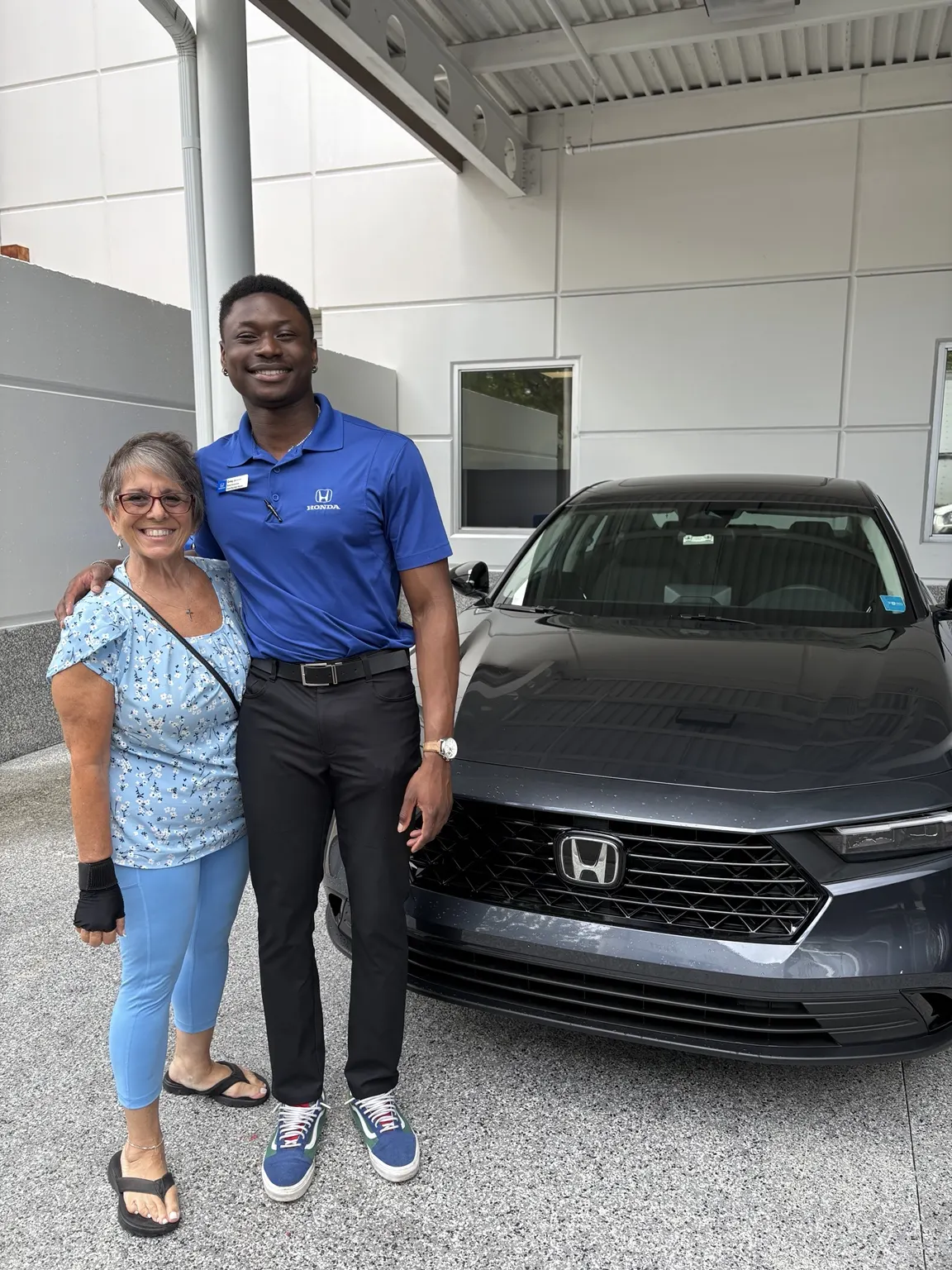 Greg with a customer and their vehicle