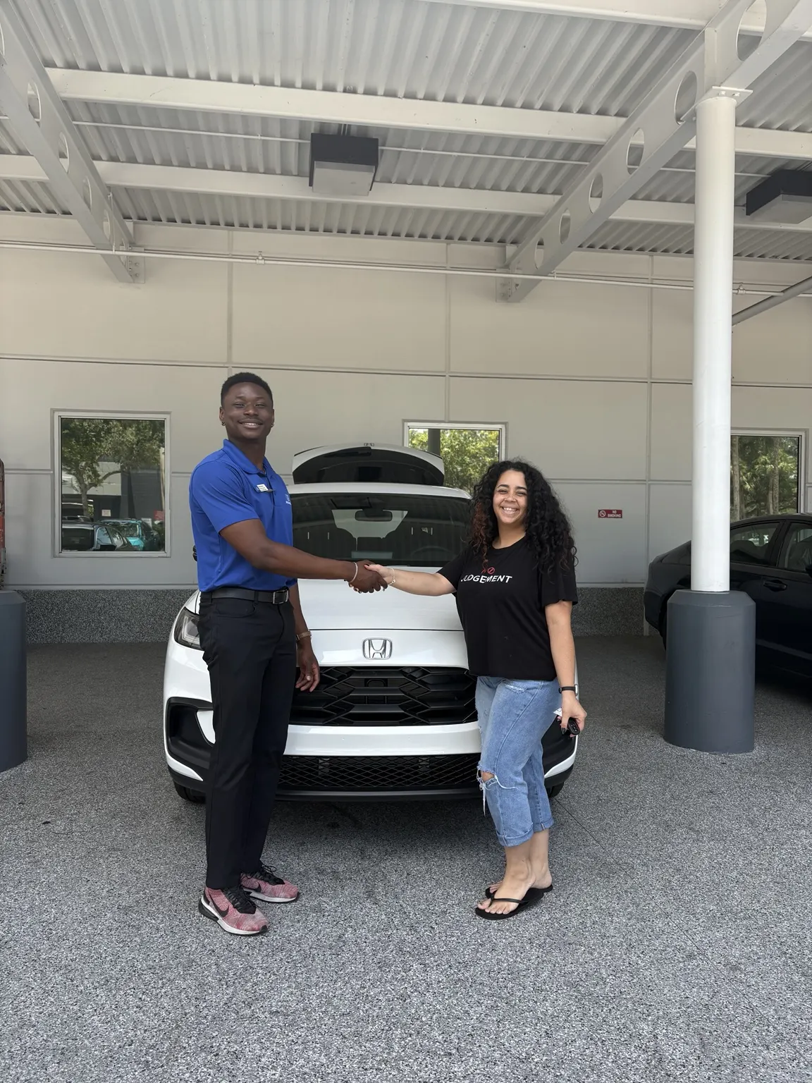 Greg with a customer and their vehicle