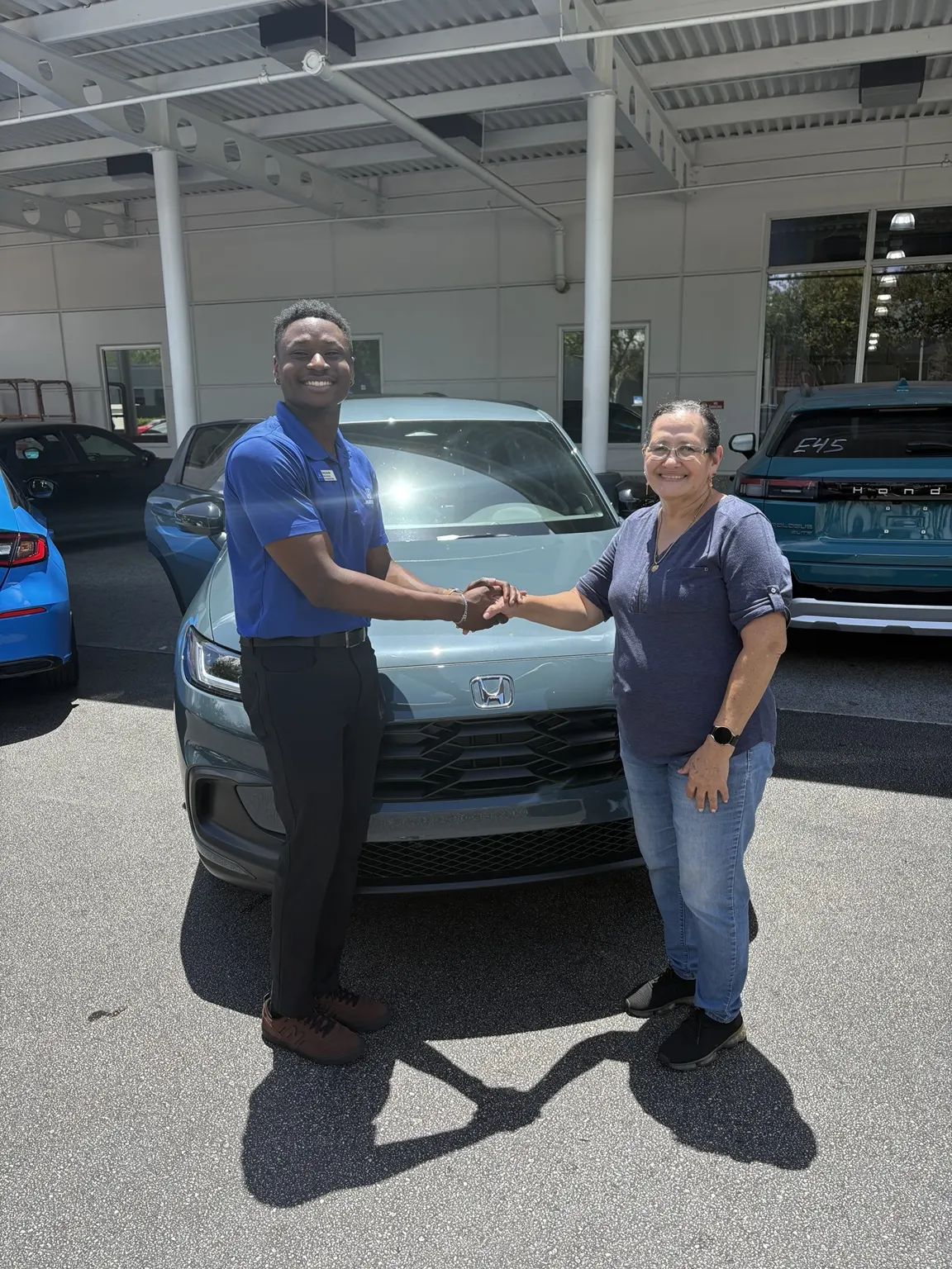 Greg with a customer and their vehicle
