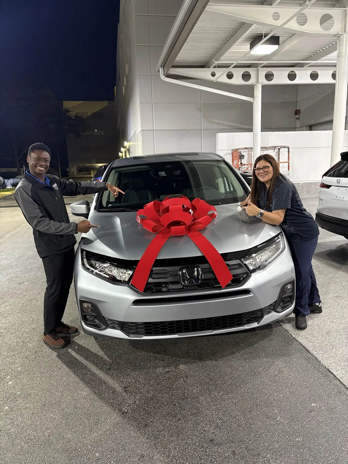 Greg with a customer and their vehicle