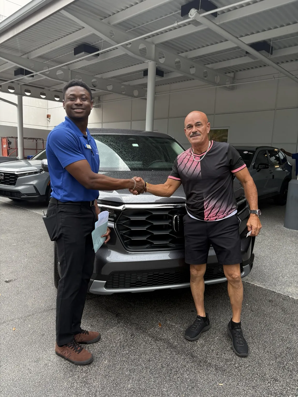 Greg with a customer and their vehicle