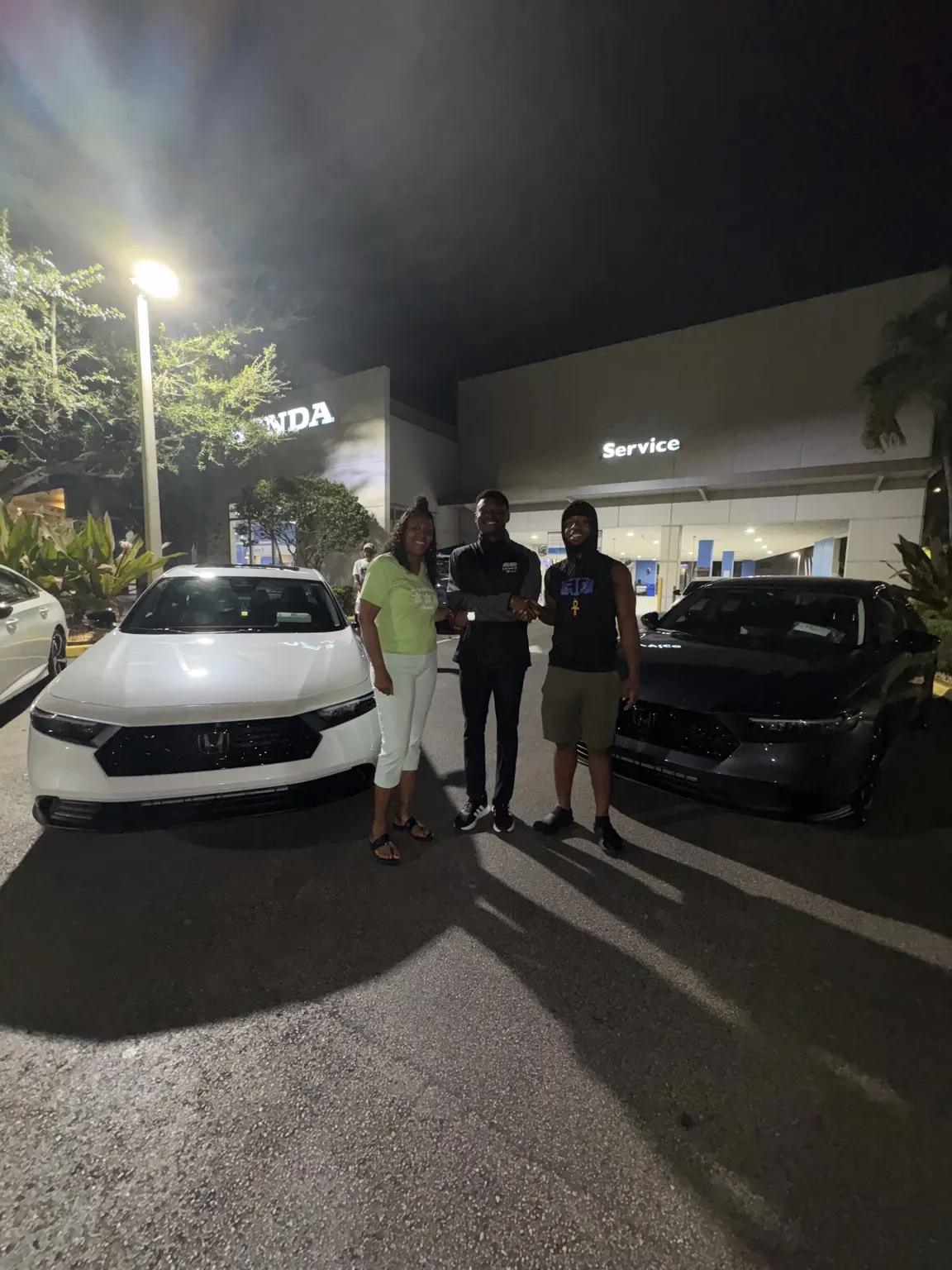 Greg with a customer and their vehicle