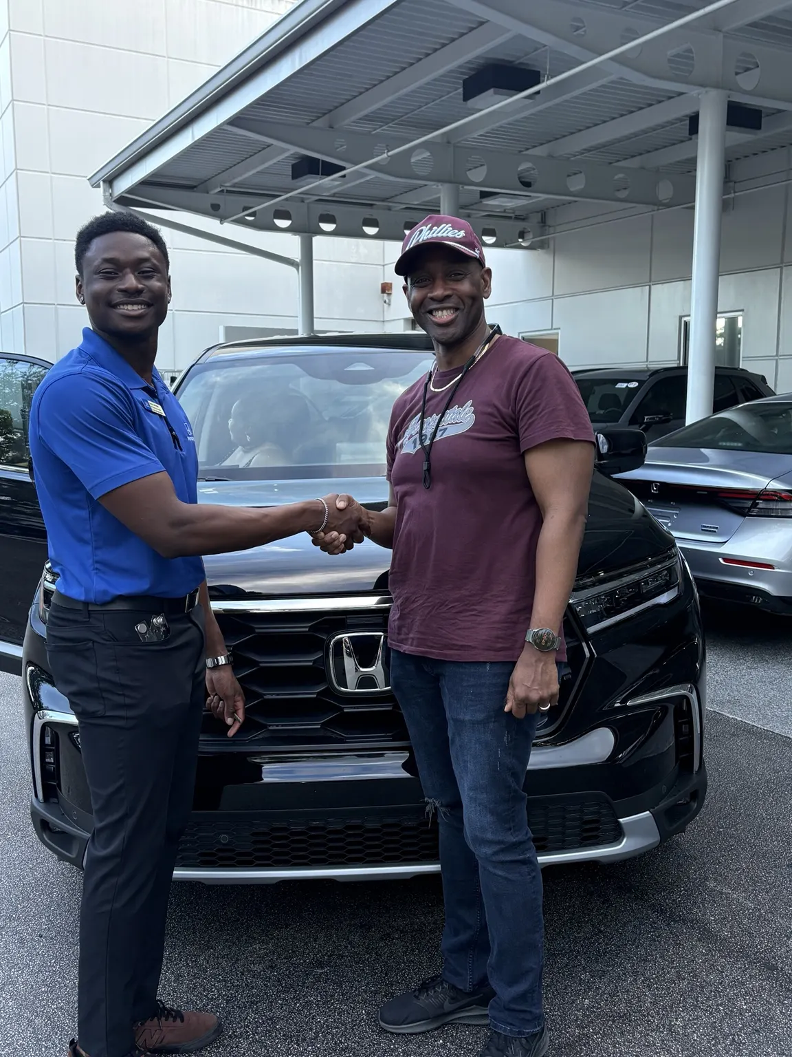Greg with a customer and their vehicle