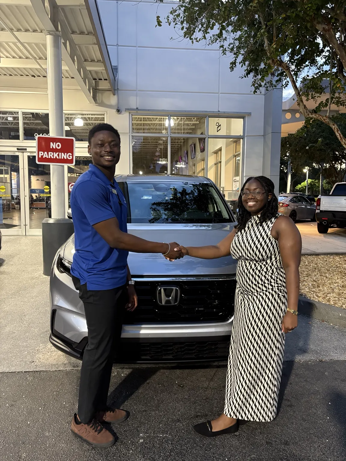 Greg with a customer and their vehicle
