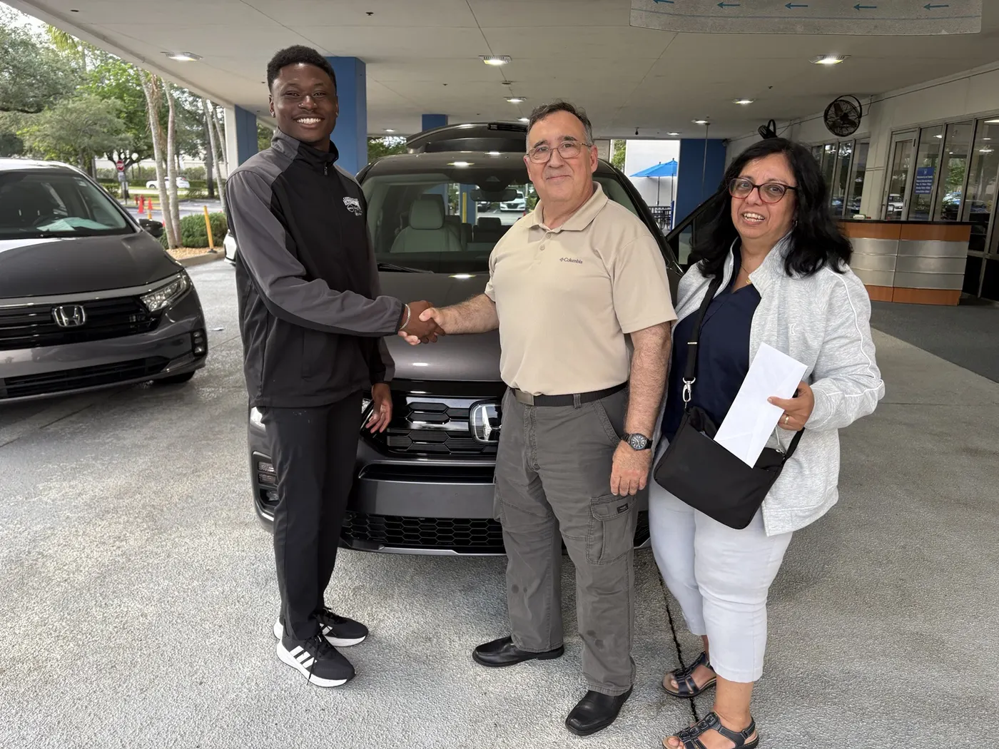 Greg with a customer and their vehicle
