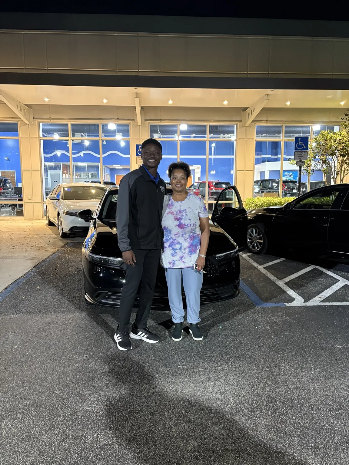 Greg with a customer and their vehicle