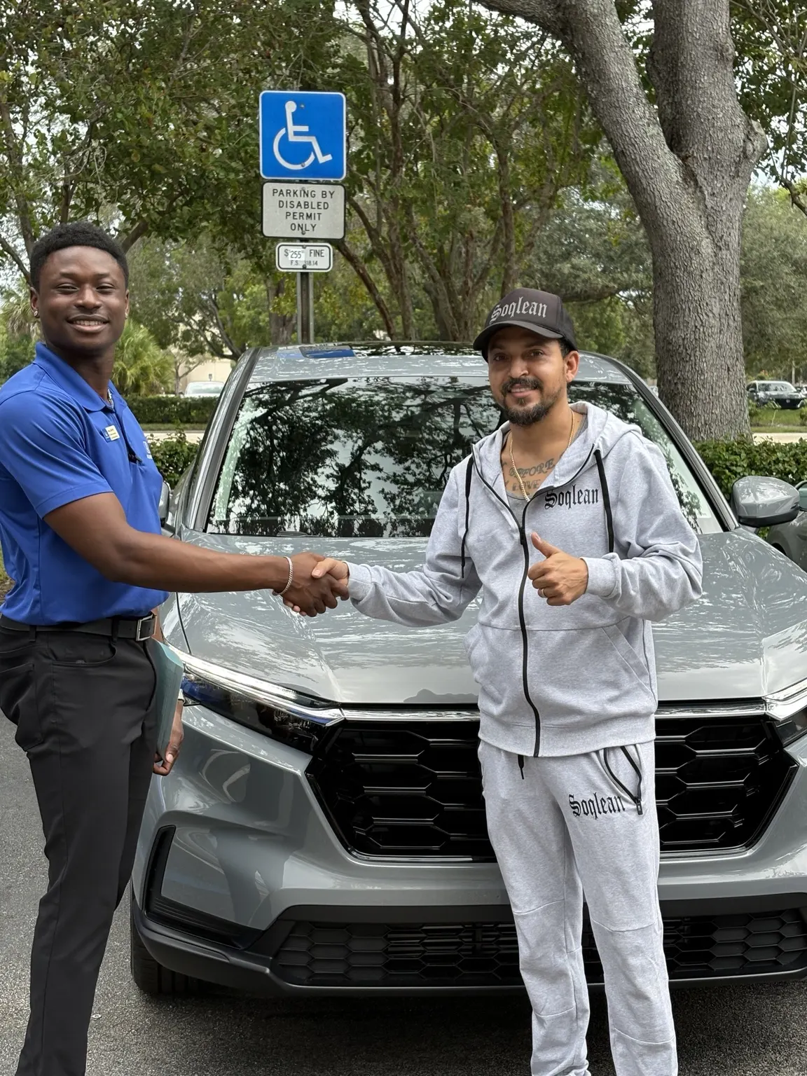 Greg with a customer and their vehicle