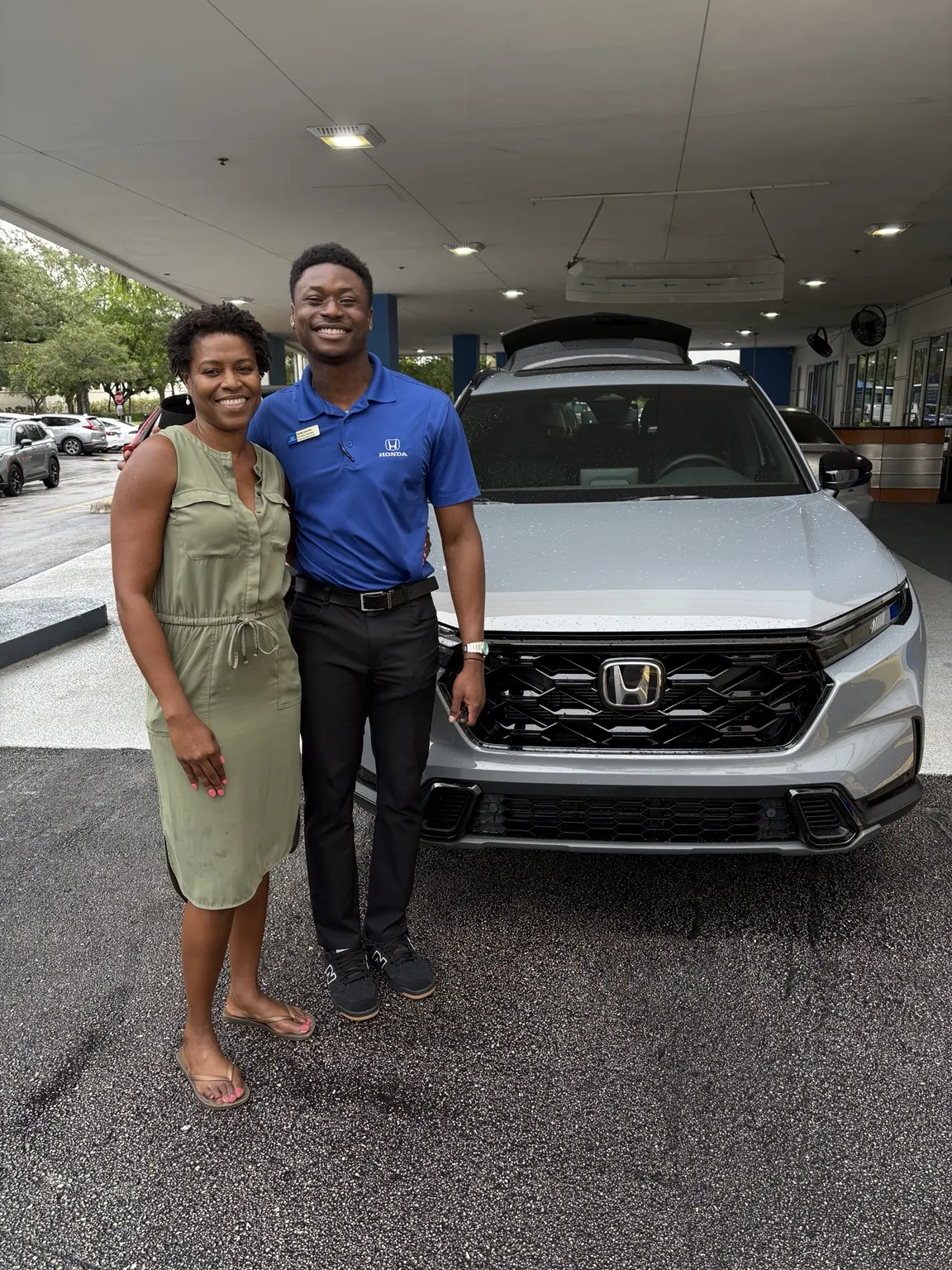 Greg with a customer and their vehicle