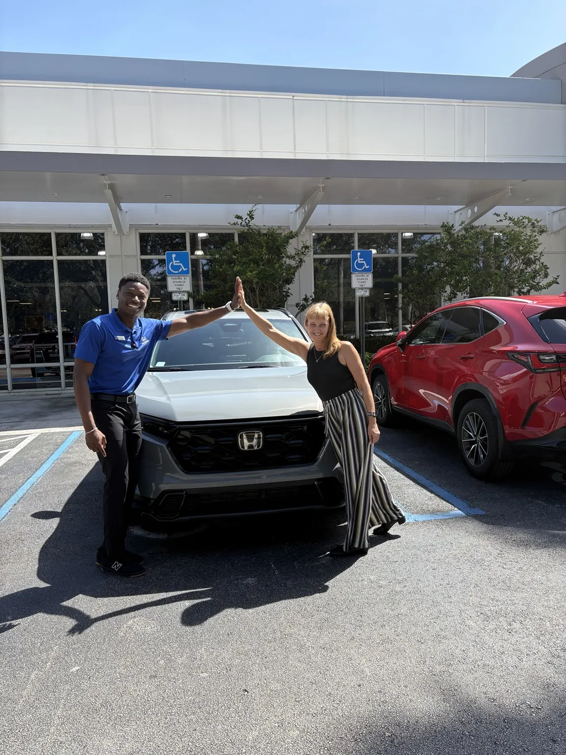 Greg with a customer and their vehicle