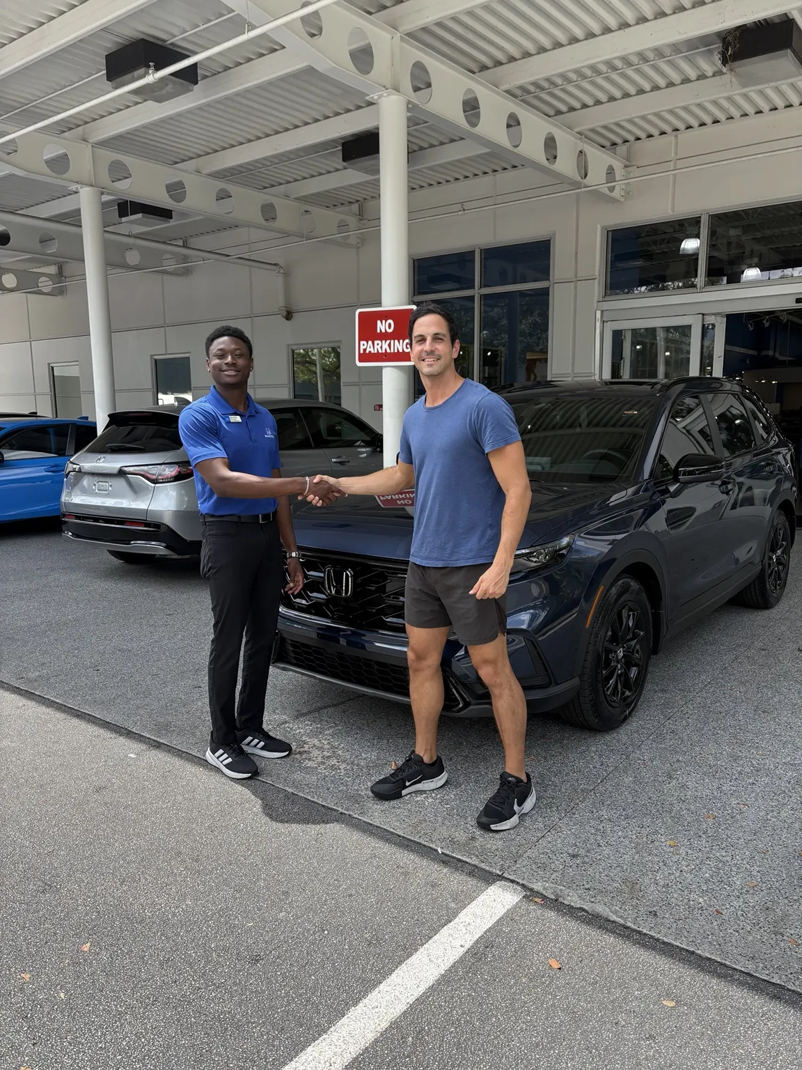 Greg with a customer and their vehicle