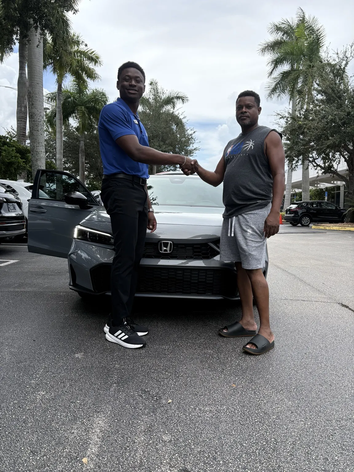 Greg with a customer and their vehicle