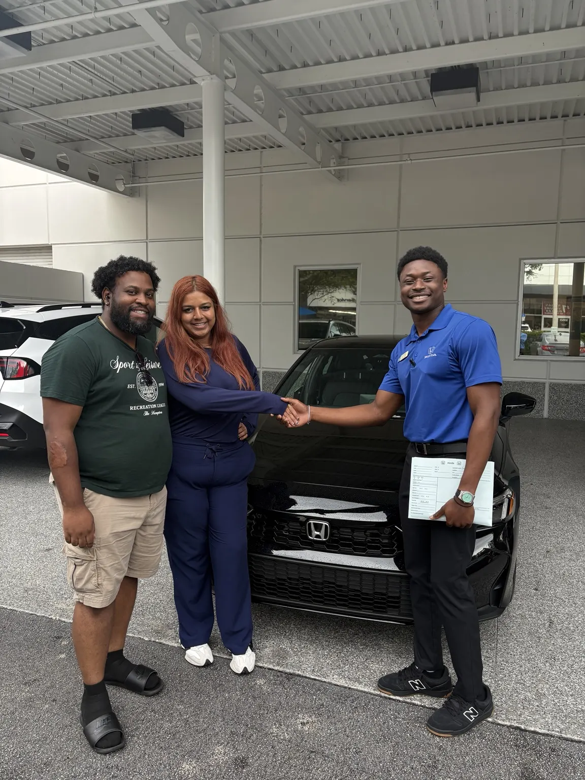 Greg with a customer and their vehicle