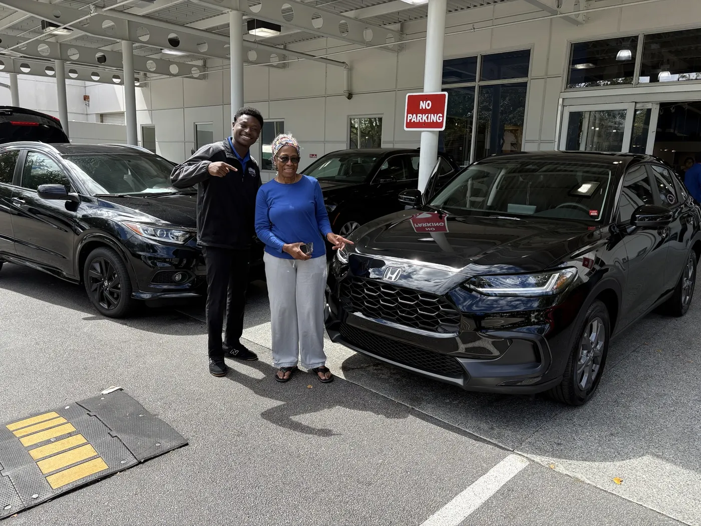 Greg with a customer and their vehicle