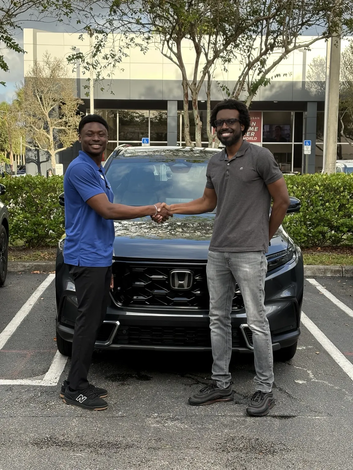 Greg with a customer and their vehicle