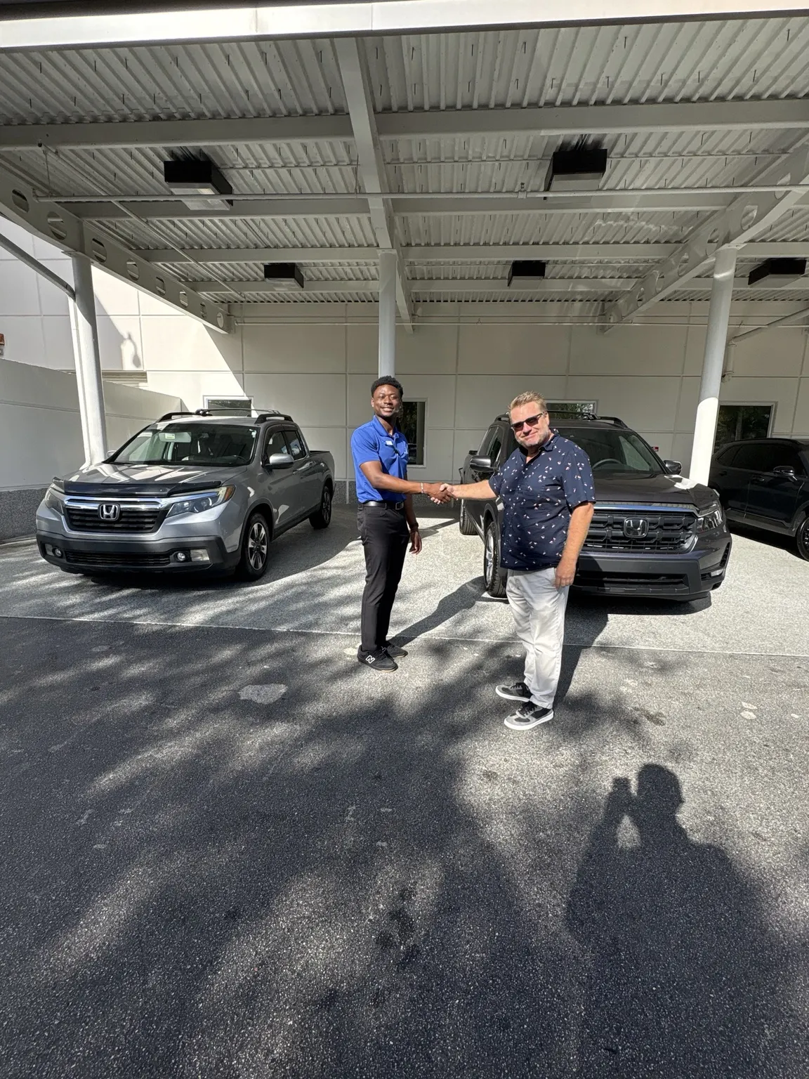 Greg with a customer and their vehicle
